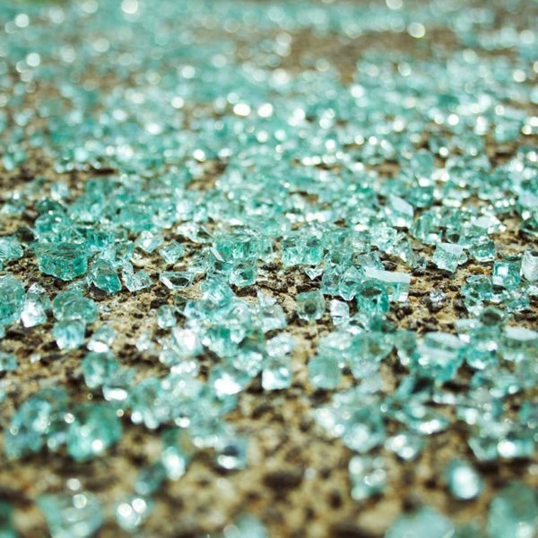 Broken glass on pavement after a motor vehicle accident