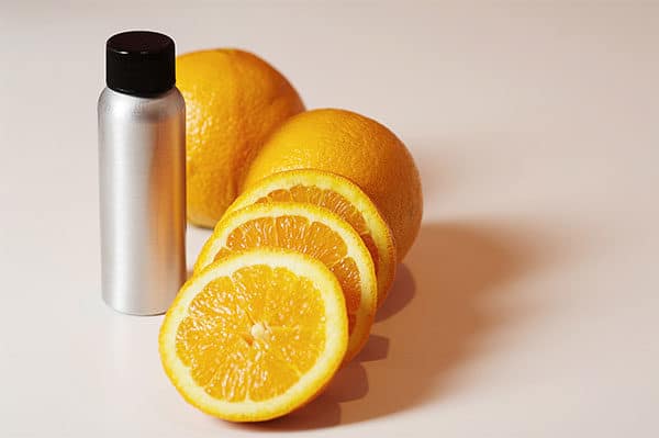 Bottle of orange oil and orange slices