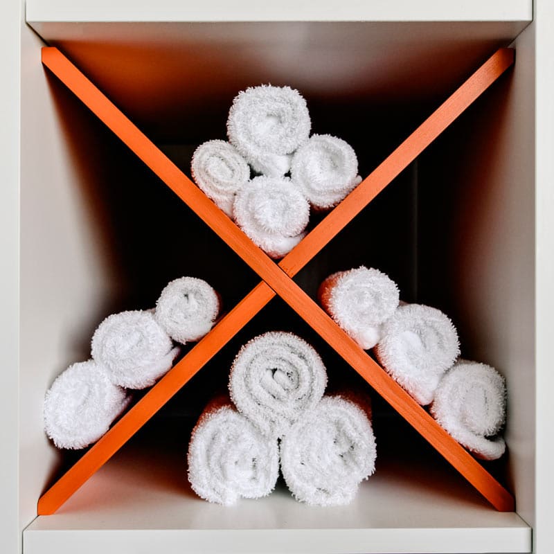 A selection of towels rolled up in a cubby