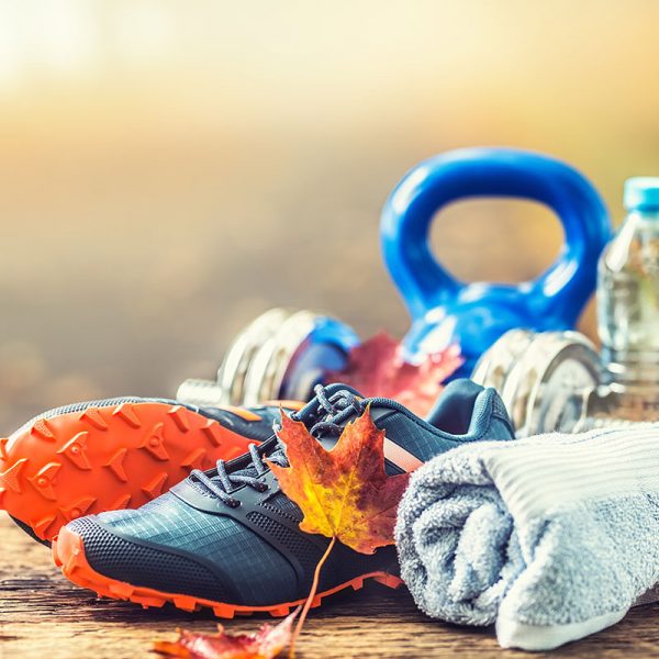 Workout gear: running shoes, kettlebell, water bottle, and towel.