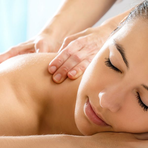 A smiling woman receiving a massage
