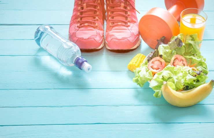 Water bottle, sneakers, a dumbbell, and a bowl of salad.