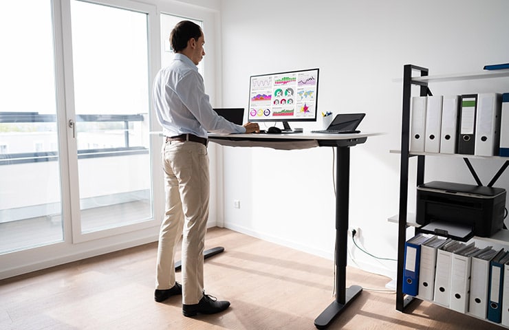 A man using a standing desk. 