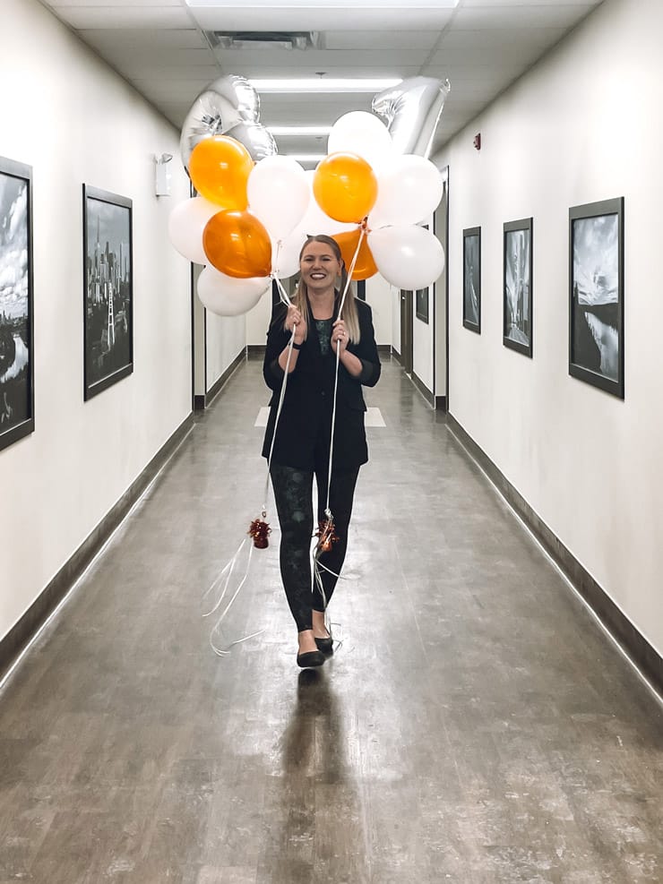 Woman carrying birthday balloons